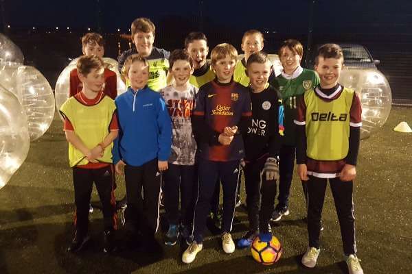 Boys from Kinvara playing Bubble Football under lights at Astrobay.