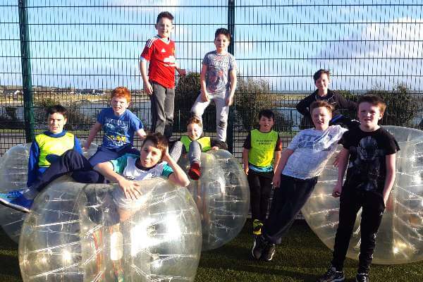 Group of teenagers after playing a round of Bubble Football at a birthday party in Astrobay.