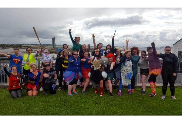 Superheroes hen party pose for team photo